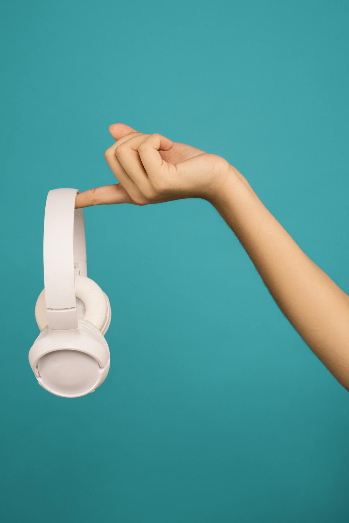 Person holding over-ear headphones. Image: MTW