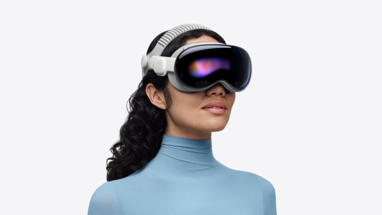 Apple Vision Pro headset official product shot showing the curved glass front and dual-loop strap