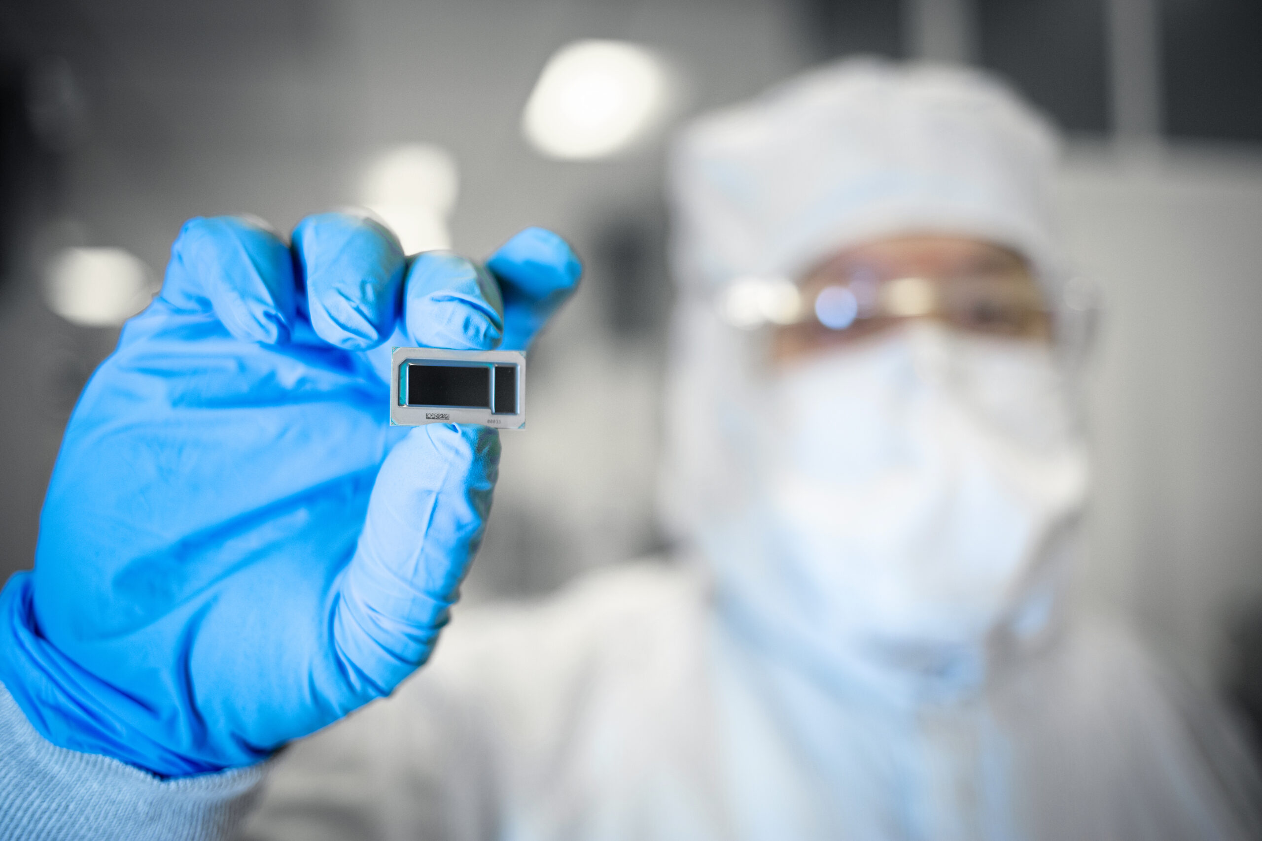 Intel manufacturing employee displays chip built on glass substrate. Image: Intel