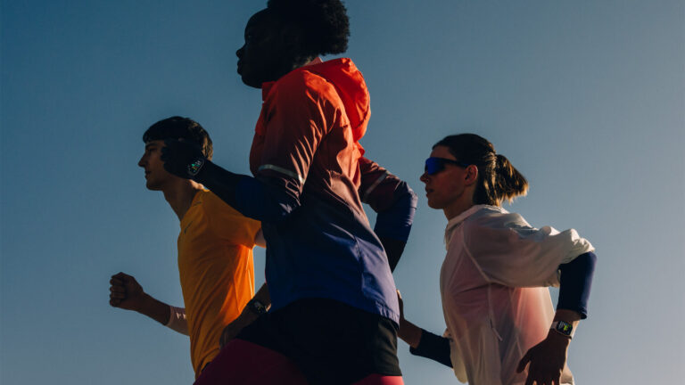 Apple Watch vs Galaxy Watch UK 2026 lifestyle shot of three runners wearing Apple Watch Series 11