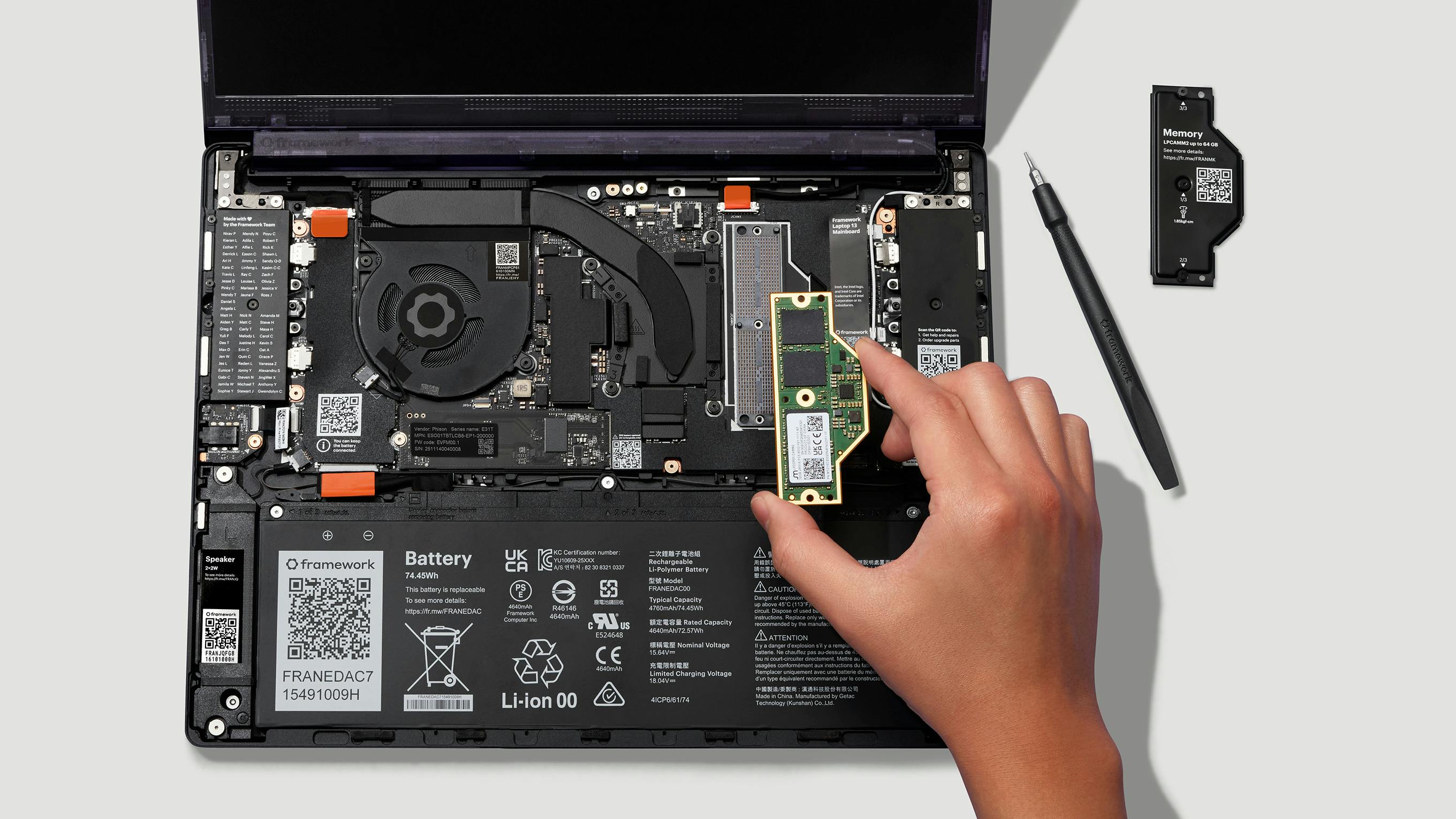 Framework Laptop 13 Pro LPCAMM2 memory module being installed by hand