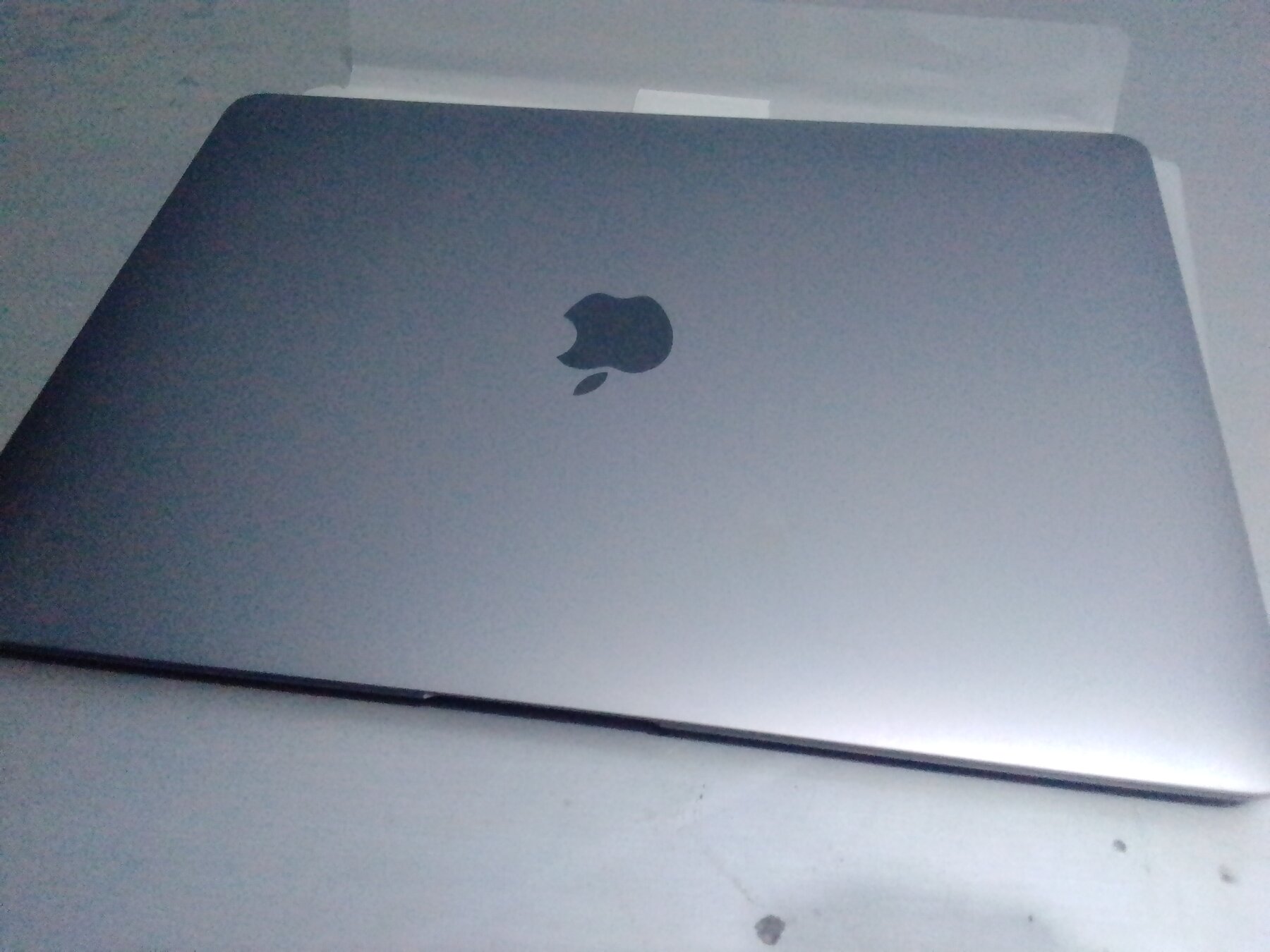 watchOS 26.5 RC paired with Apple devices on a MacBook Air front view