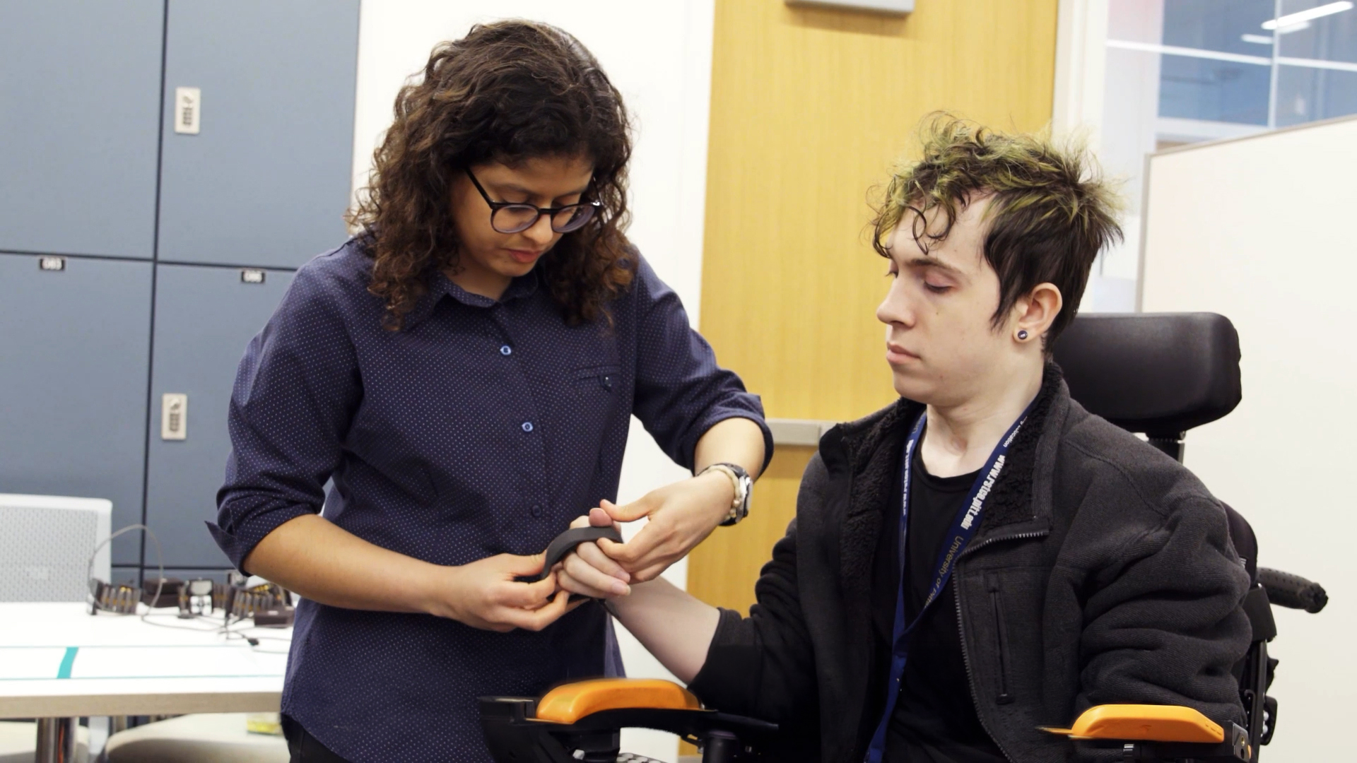 Meta AI glasses accessibility user Cass wearing the Meta Neural Band EMG wristband