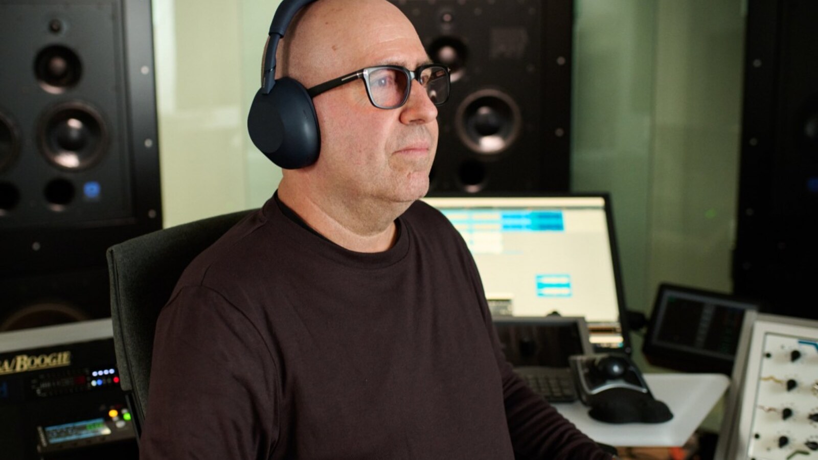 Sony WH-1000XM6 vs Bose: a mastering engineer wearing the black Sony WH-1000XM6 in a studio