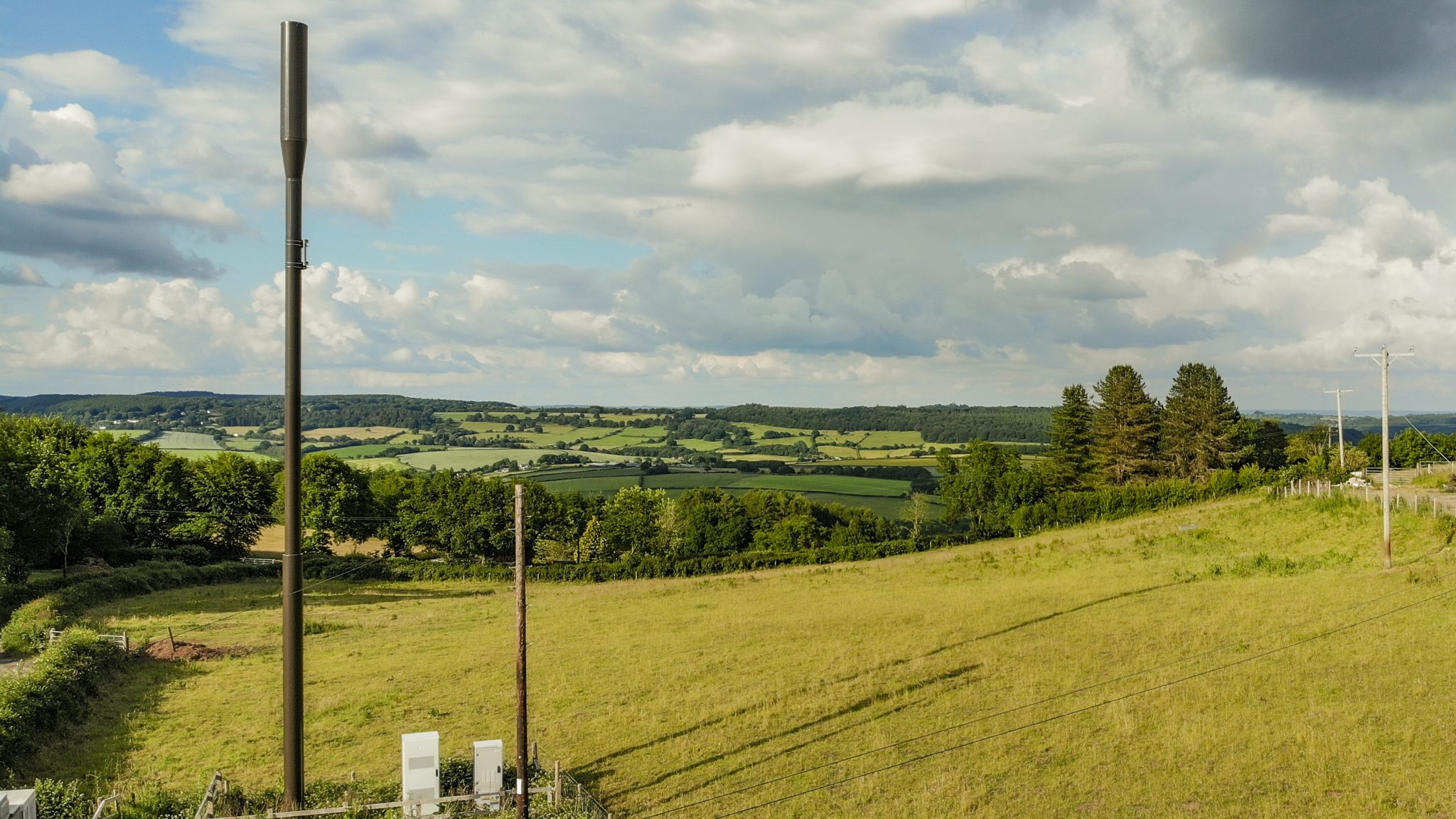 VodafoneThree satellite service complements rural mobile masts like this one in the UK countryside