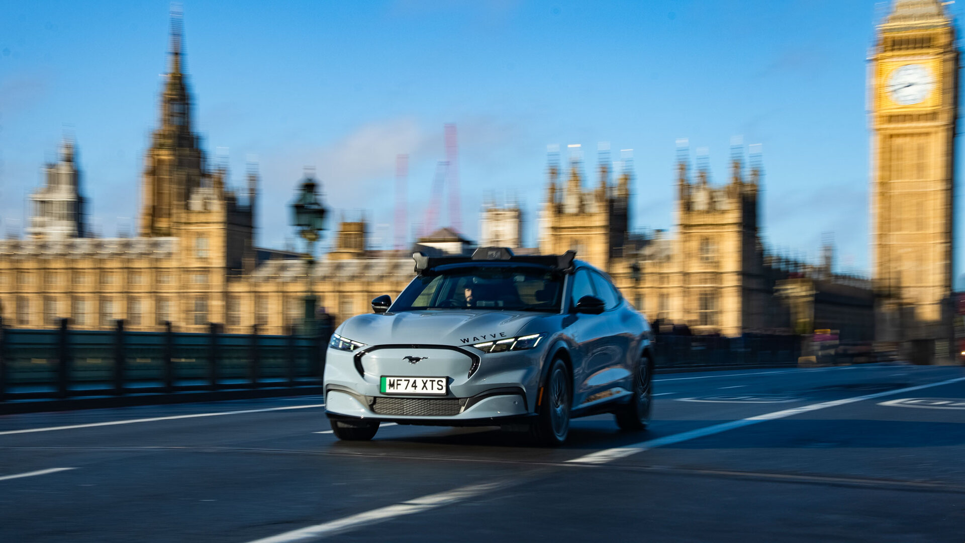 Wayve Stellantis partnership self-driving test car on a London bridge