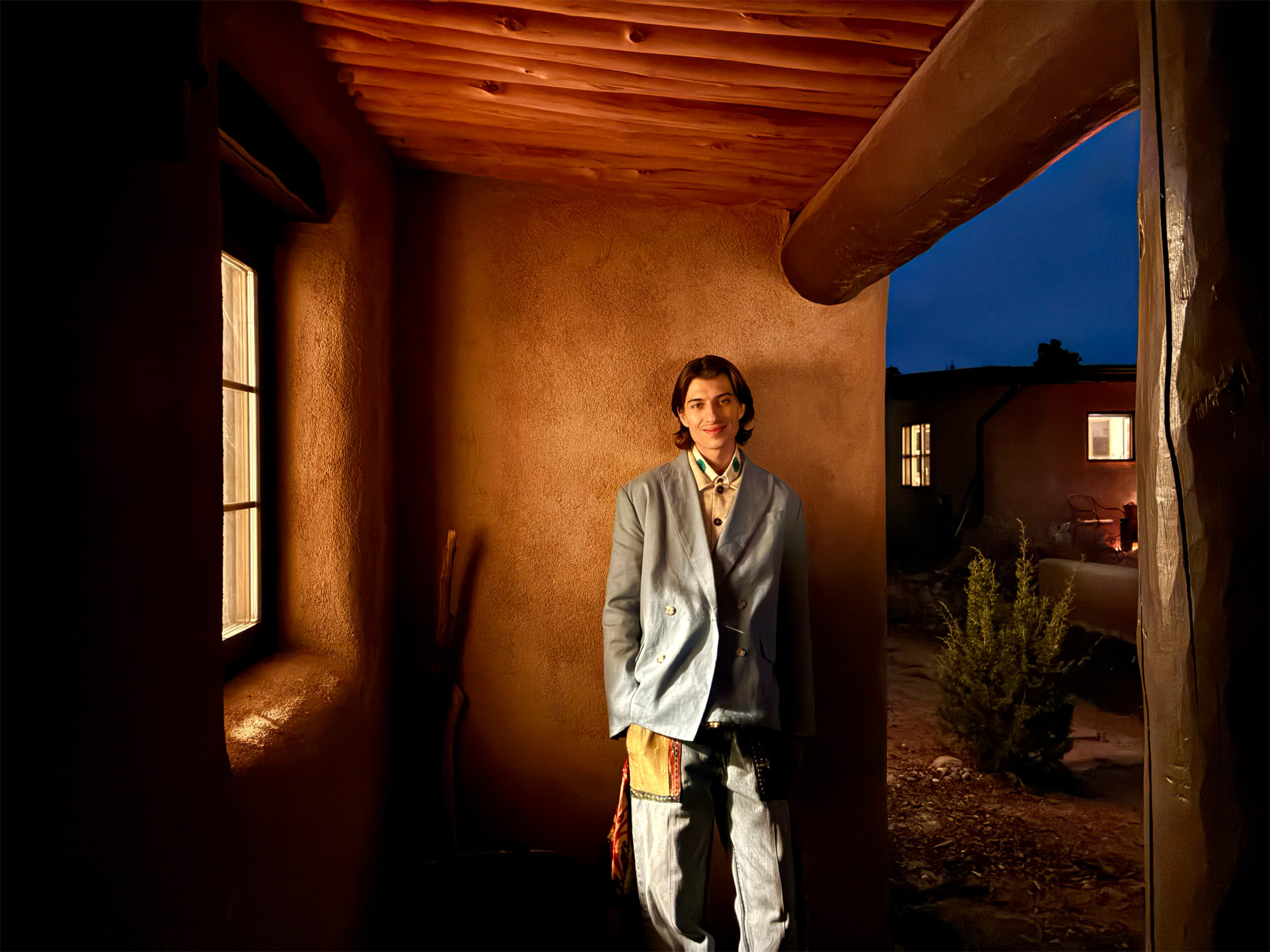 Dusk portrait by an adobe house shot in Night mode on the iPhone 16e