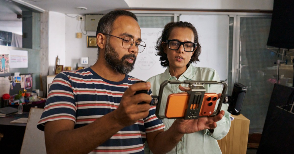 Filmmaker shooting a scene on an iPhone as part of the Filmed on iPhone MAMI Select programme