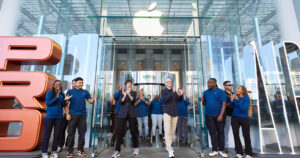 Latest iPhone, Apple Watch and AirPods arranged on a display table inside an Apple Store
