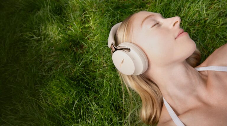 Bose QuietComfort Ultra Headphones in Driftwood Sand colourway on a stylised background