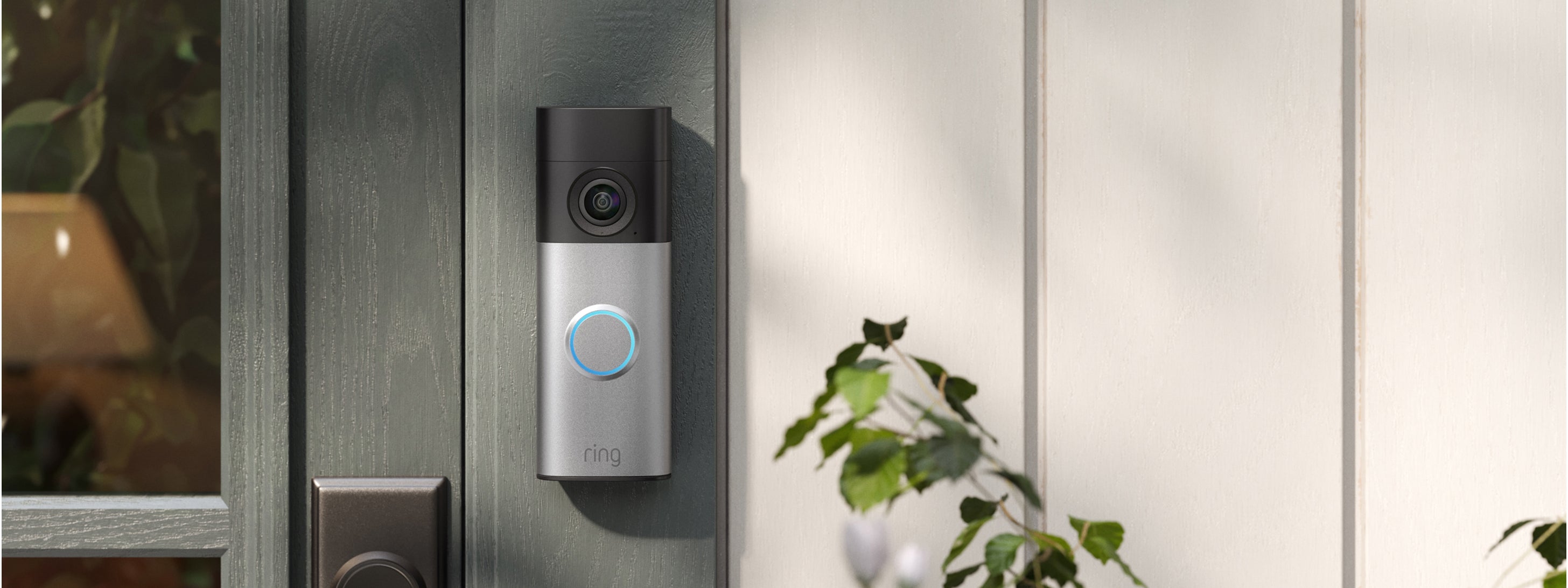 Ring Battery Video Doorbell Plus 2nd Gen mounted on grey siding beside a front door
