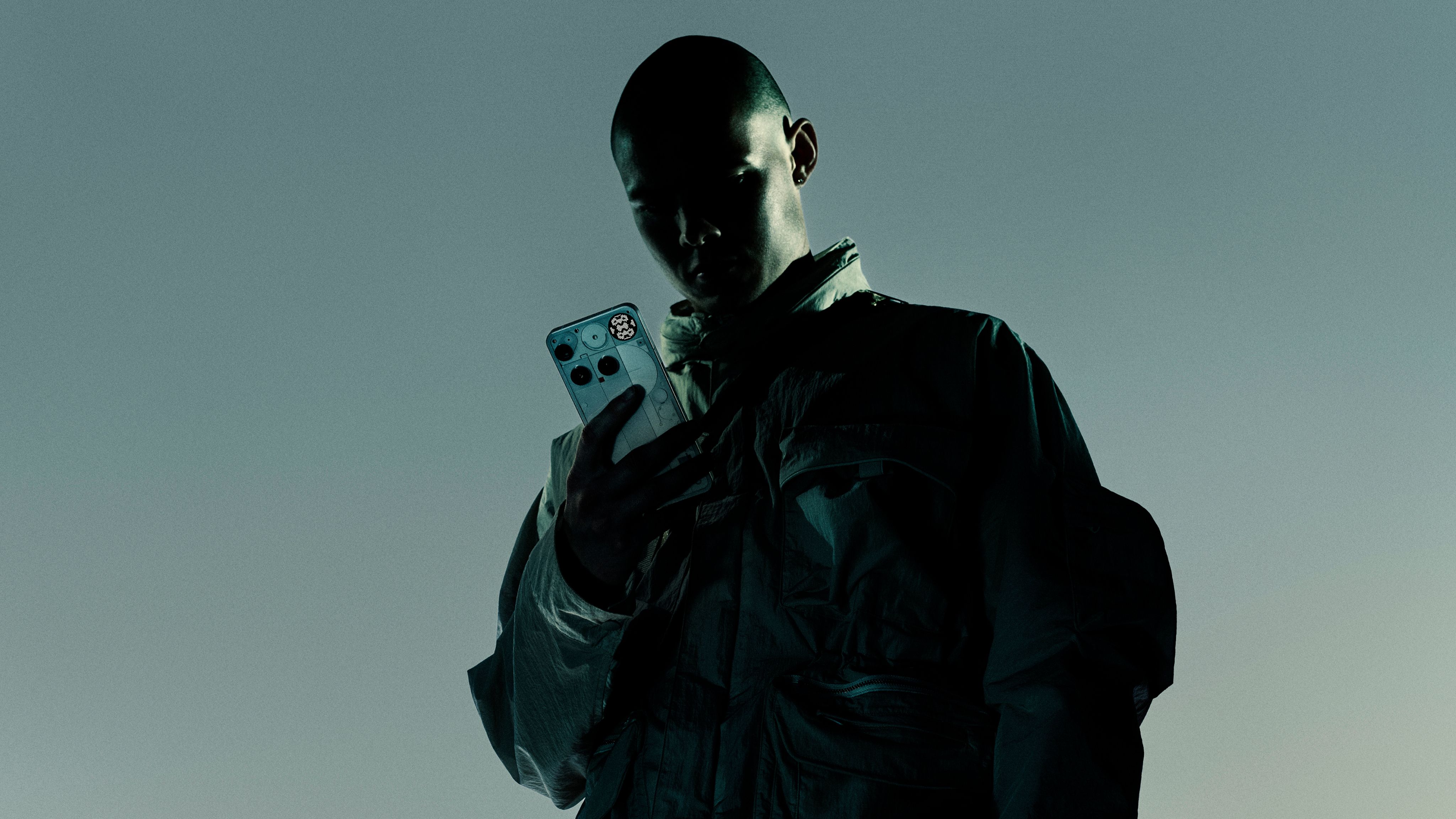 Person holding the white Nothing Phone (3) showing its rear panel