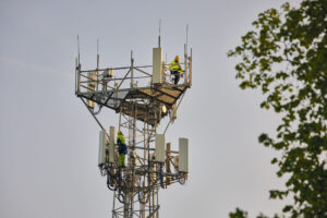 VodafoneThree network engineer working on a 5G mast
