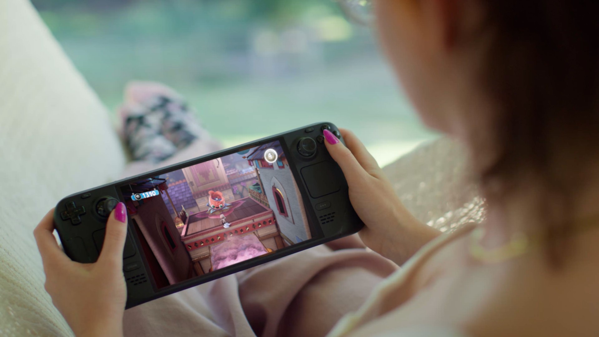 Person reclining and playing a colourful platformer on a Steam Deck OLED held in both hands