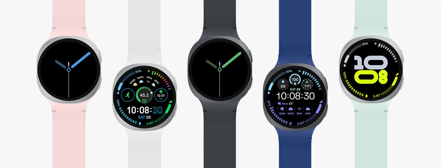 Five current Samsung Galaxy Watch models in different strap colours showing watch faces