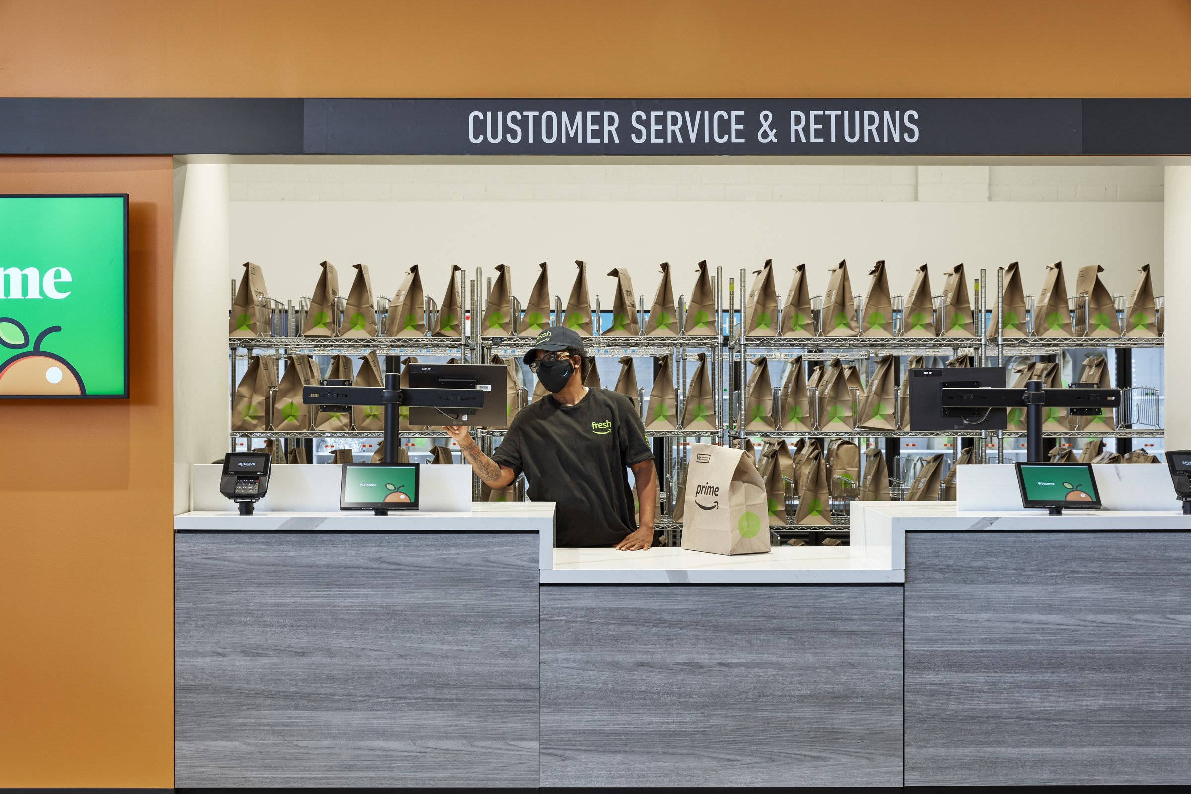 Amazon returns counter staffed by a worker, illustrating UK refund and return rights during a sale