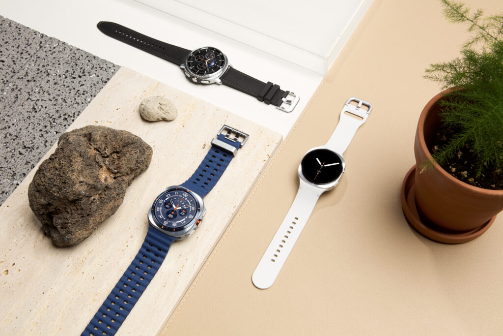 Galaxy Watch 8 vs Apple Watch comparison: three Samsung Galaxy Watch 8 and Classic models laid out on a styled surface