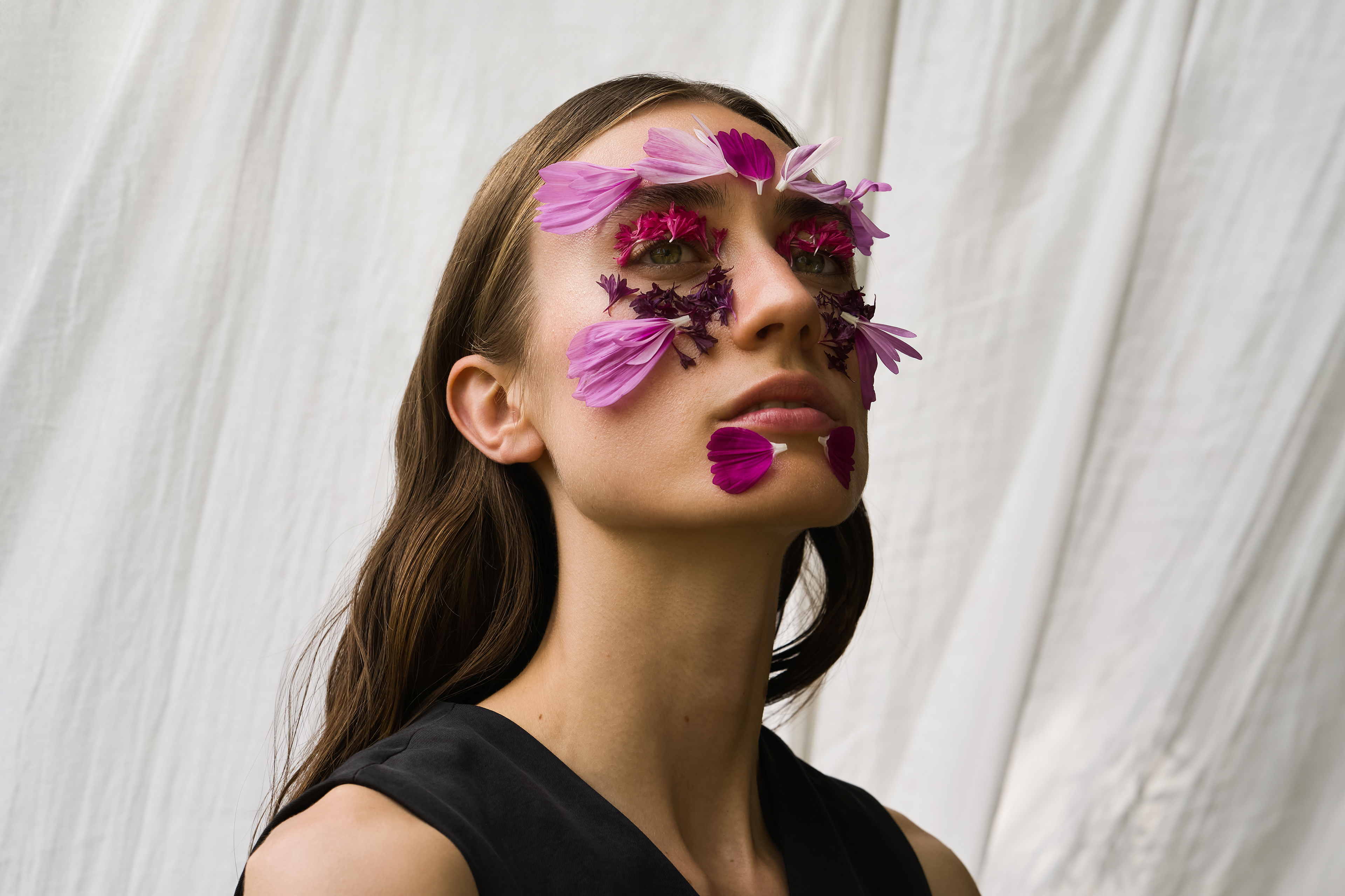 Studio portrait of a model with flower petals on her face shot on the Leica Q3 43