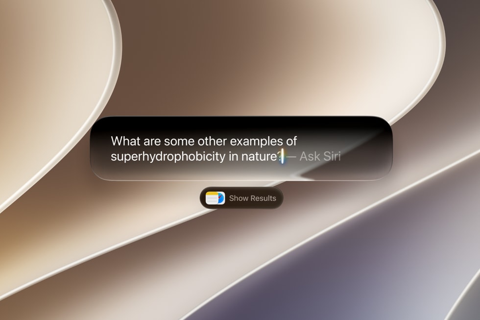 MacBook screen showing Siri AI integrated into Spotlight, answering a factual question with a conversational response