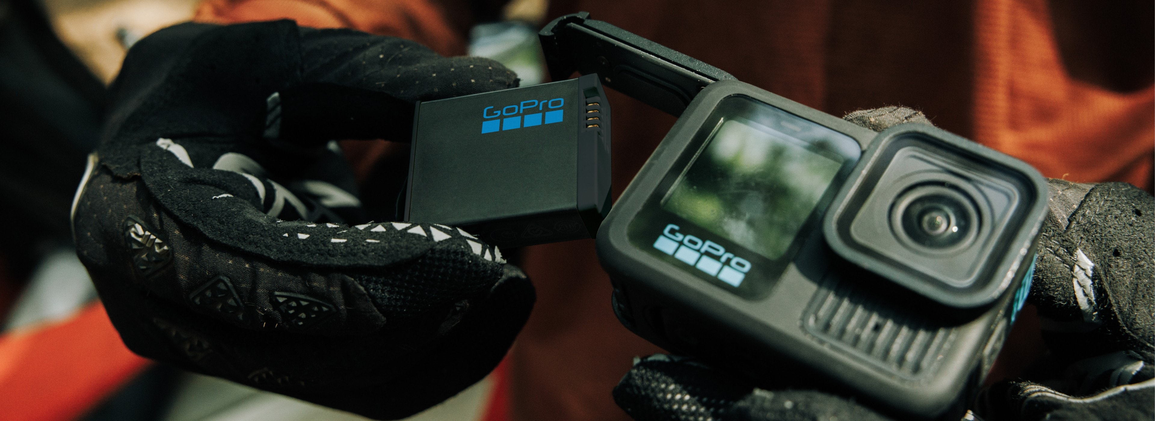 GoPro Hero 13 Black with Enduro battery inserted by a gloved rider