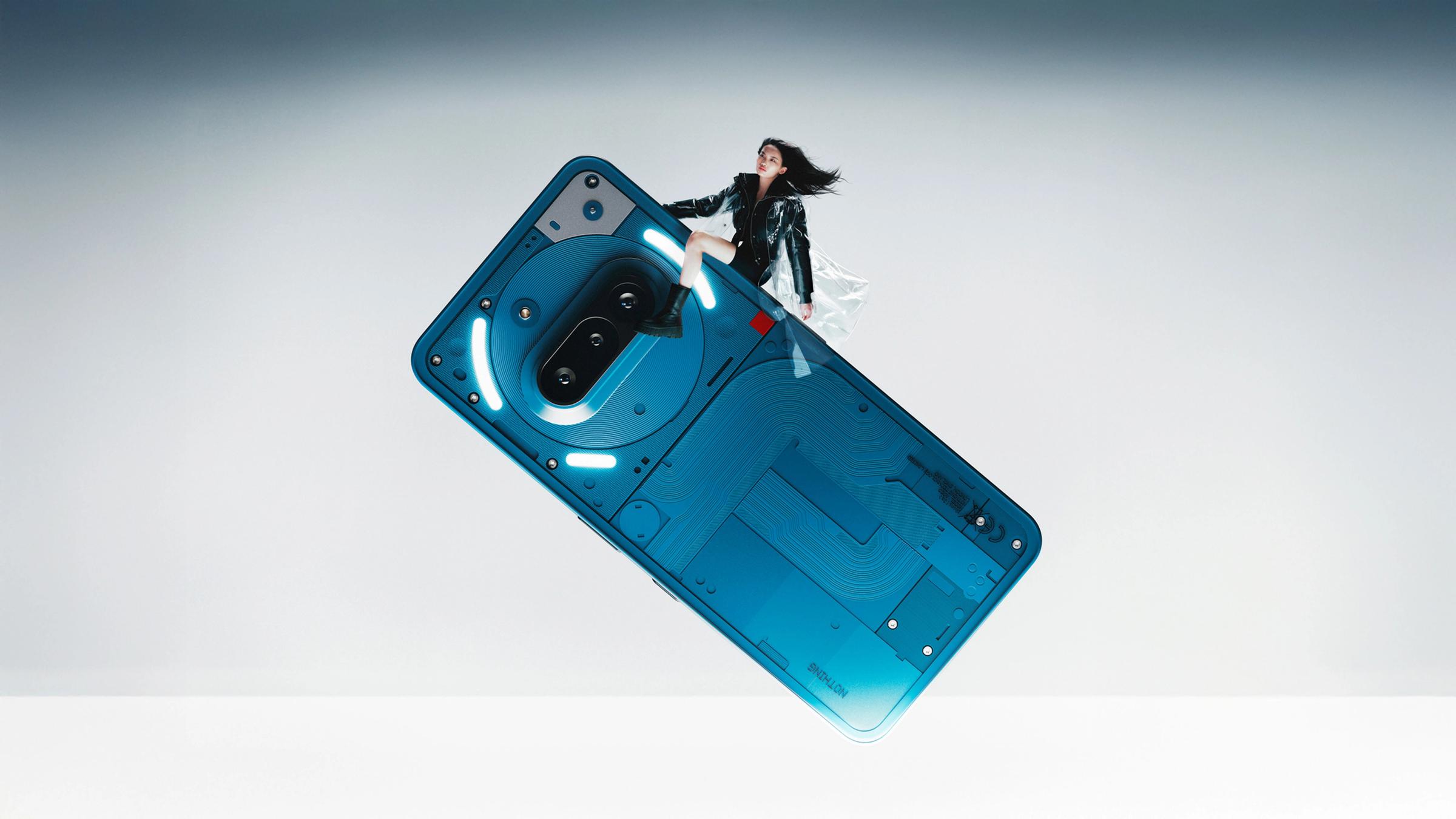 Nothing Phone 3a in blue held by a person showing the rear design and Glyph lighting