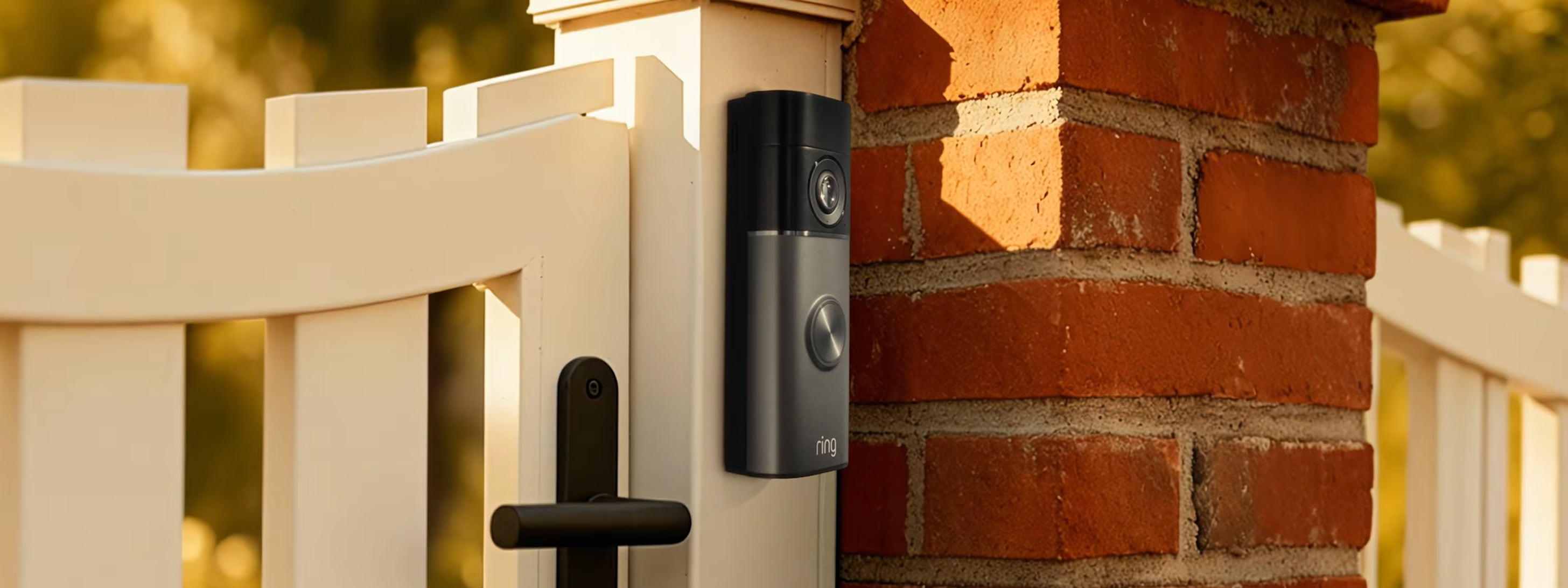 Ring Video Doorbell Pro 2nd Gen in slate mounted on a cream gate post beside a brick wall