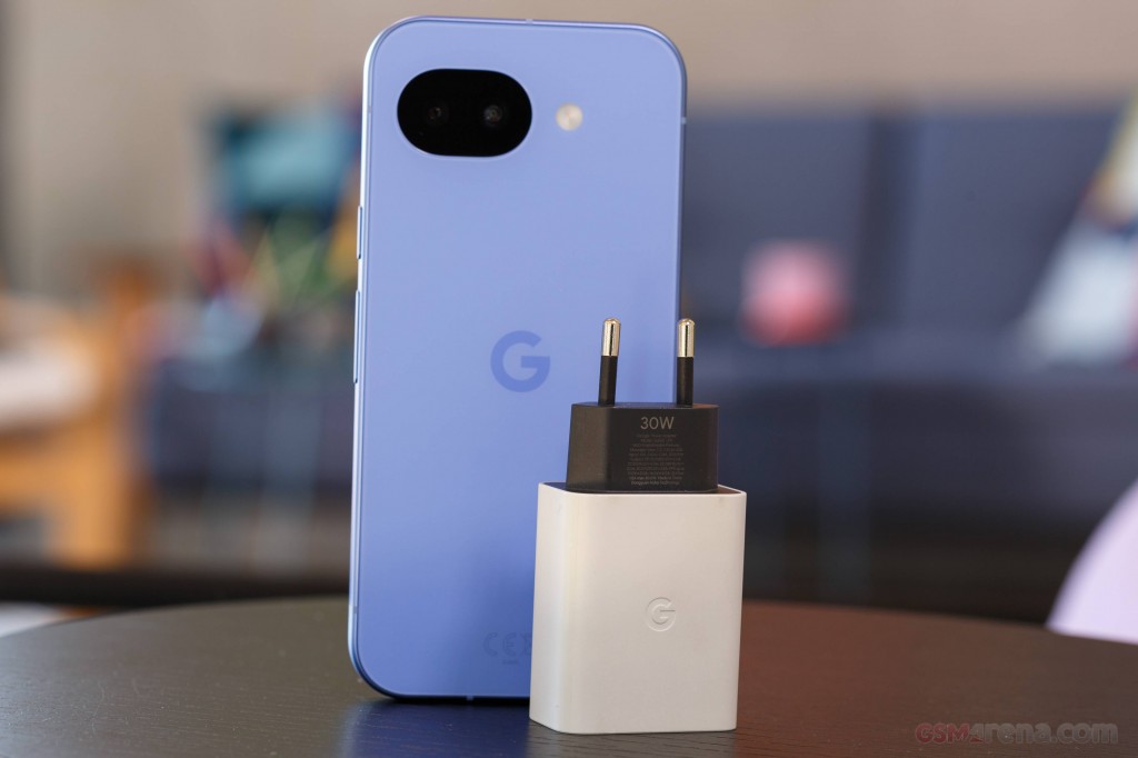 Google Pixel 10a in blue beside its 30W charger