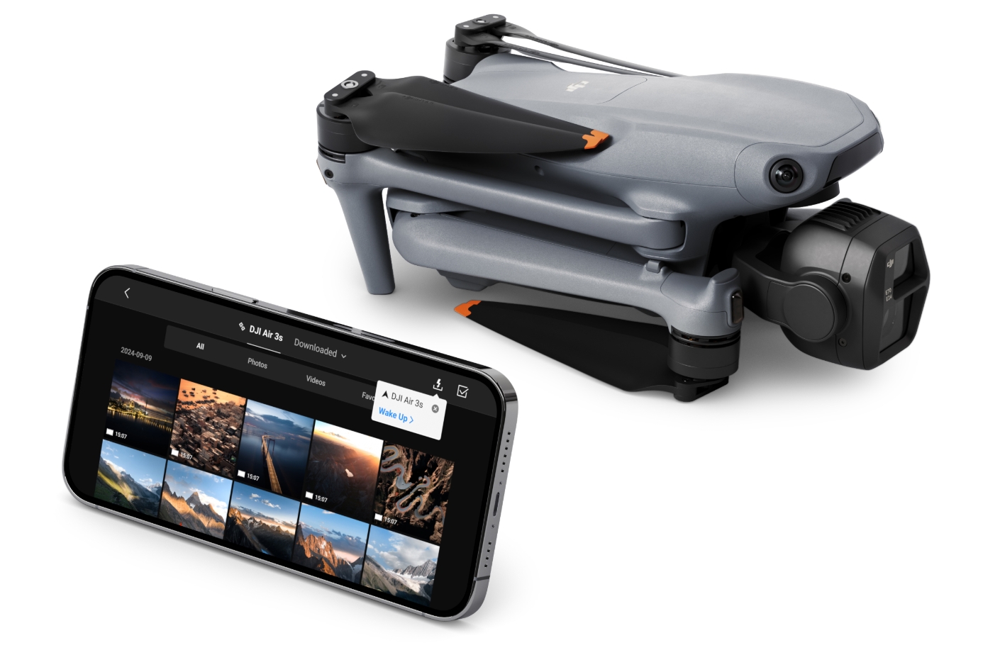 DJI Air 3S folded for travel beside a smartphone running the DJI Fly app gallery