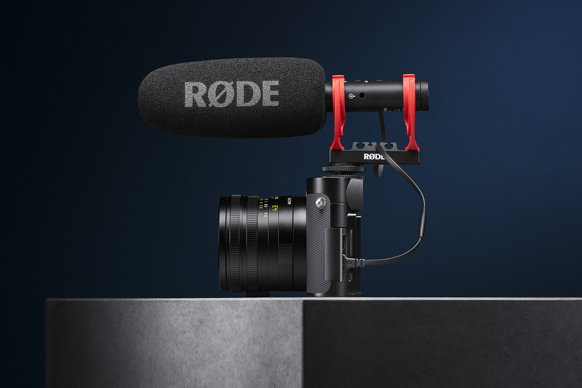 Leica Q3 43 fitted with a RODE shotgun microphone on a dark studio background
