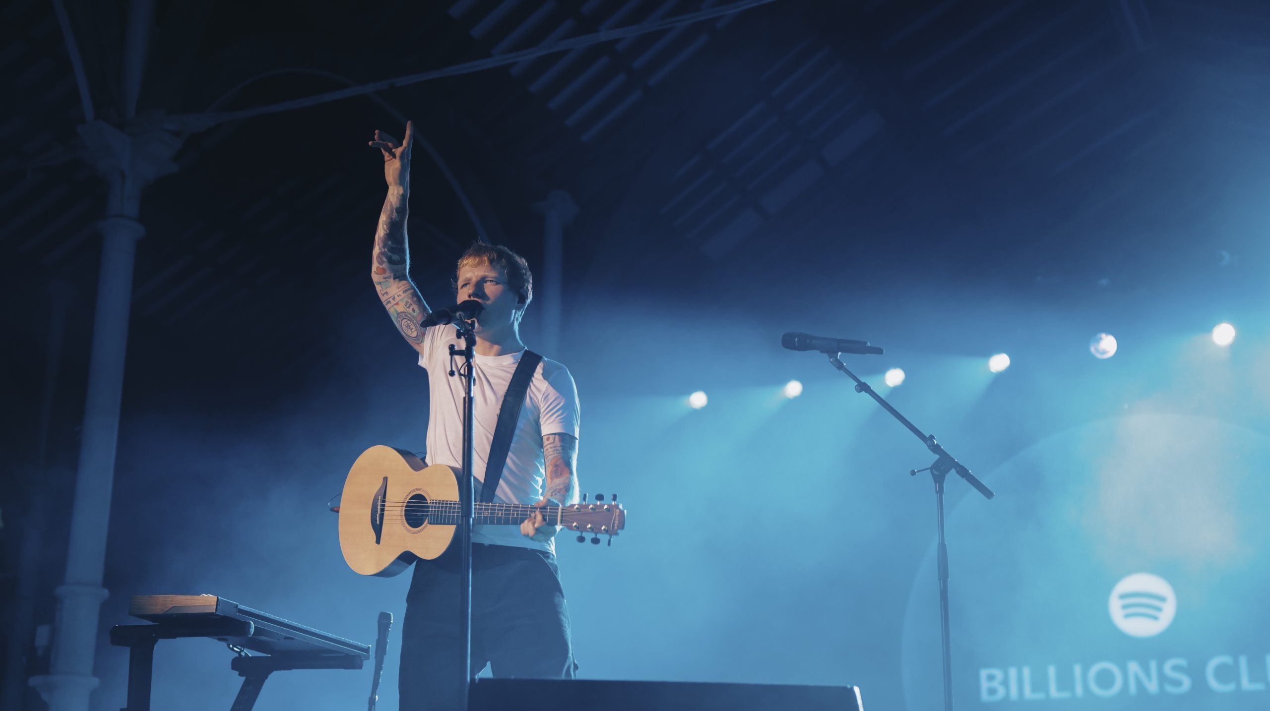 Ed Sheeran performing with a guitar at a Billions Club Live show in Dublin