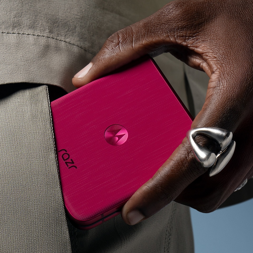 Motorola Razr Ultra flip phone folded in magenta, held in one hand