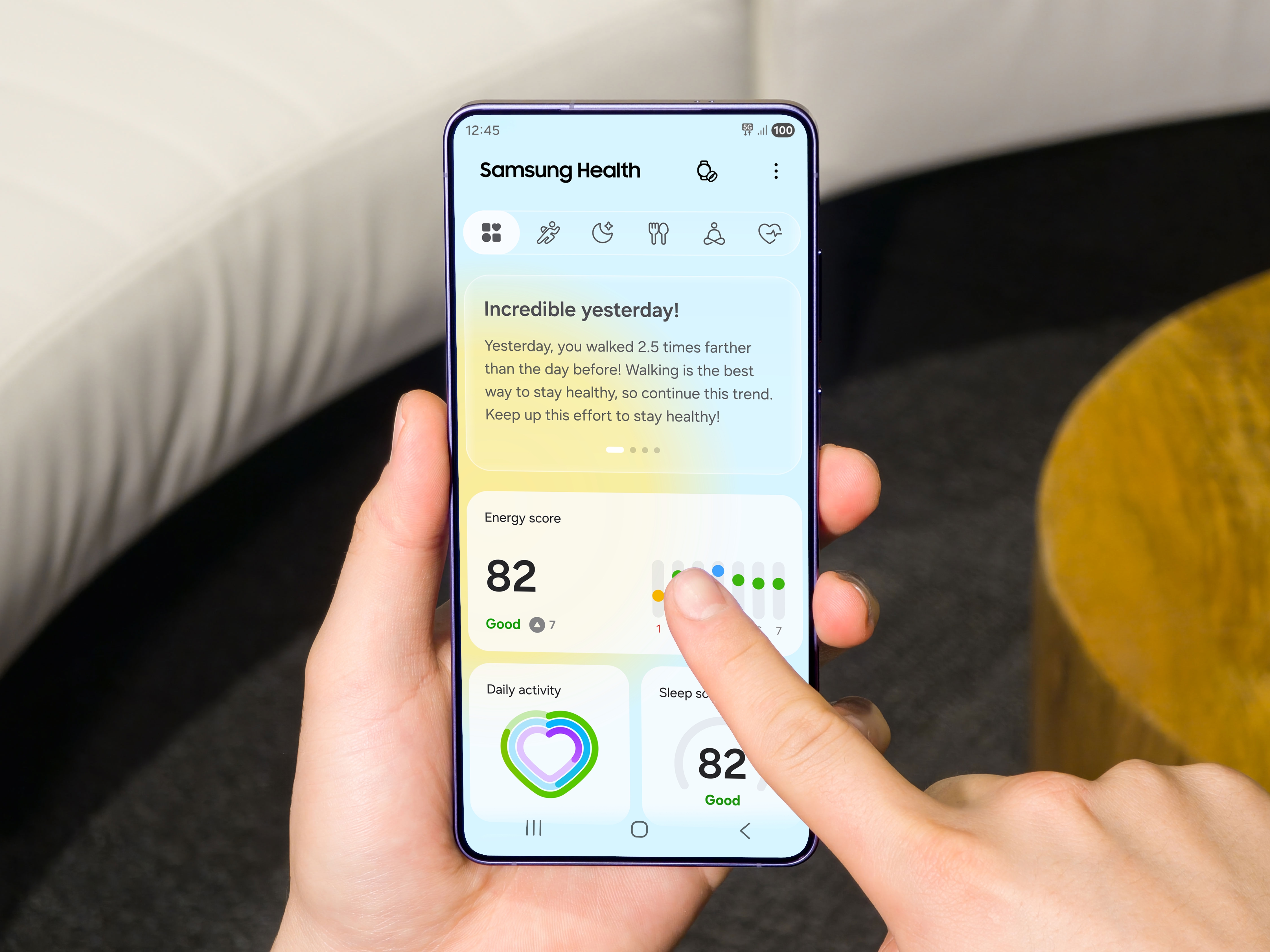 Samsung Health app showing an energy score on a Galaxy phone held in one hand