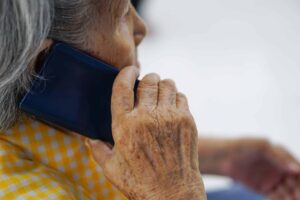 Older person making a phone call on a smartphone