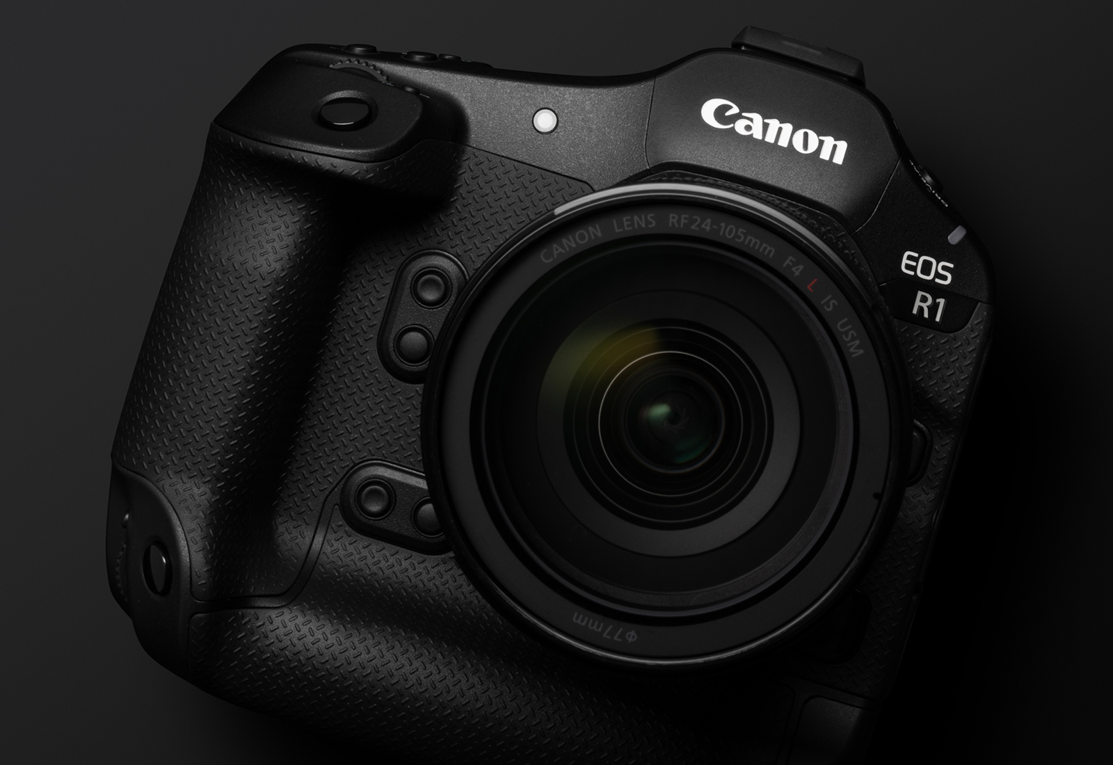 Canon EOS R1 body with RF 24-105mm lens on a dark background, front three-quarter view