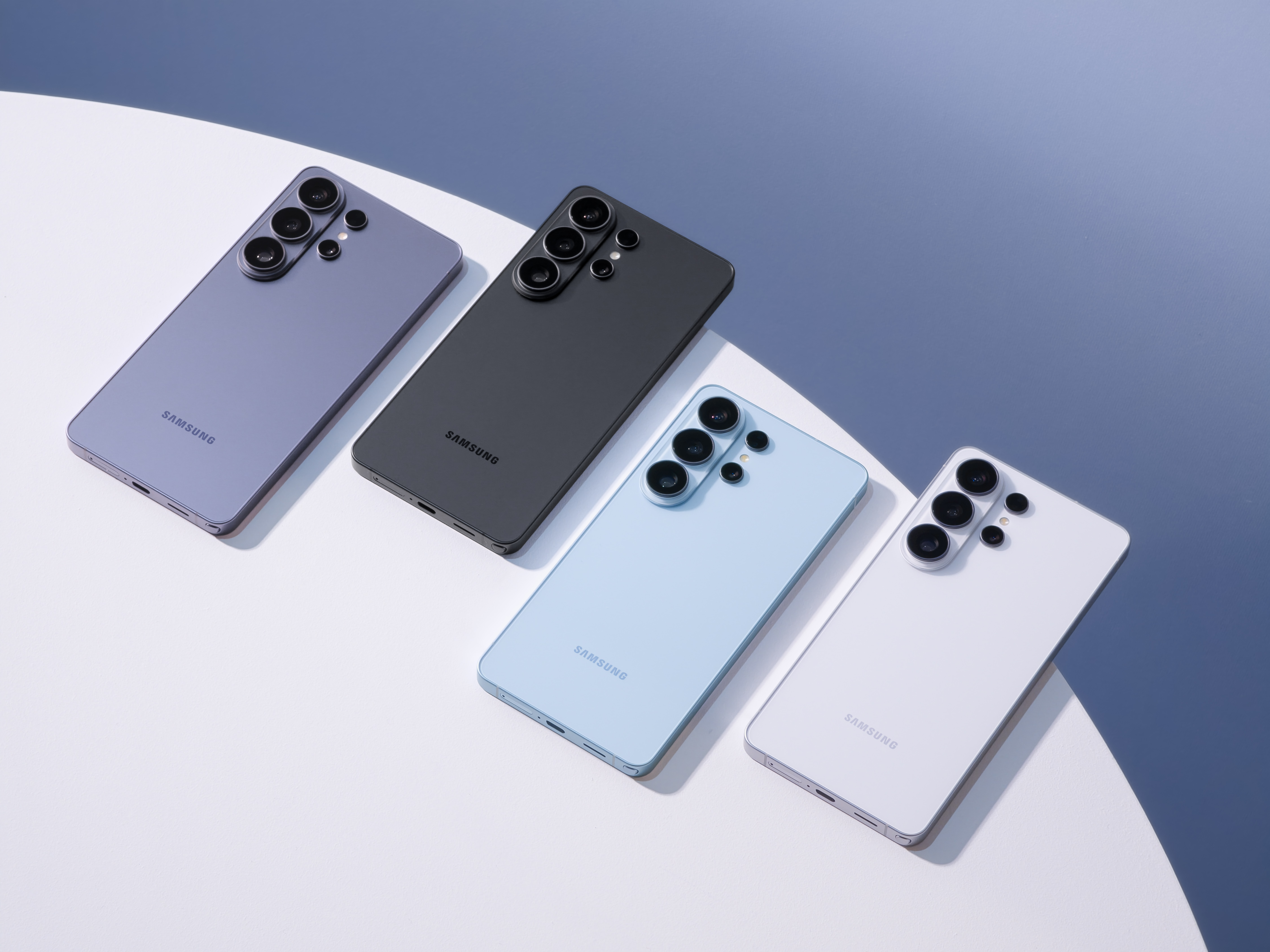 Samsung Galaxy S26 phones lying flat in four colours on a white surface