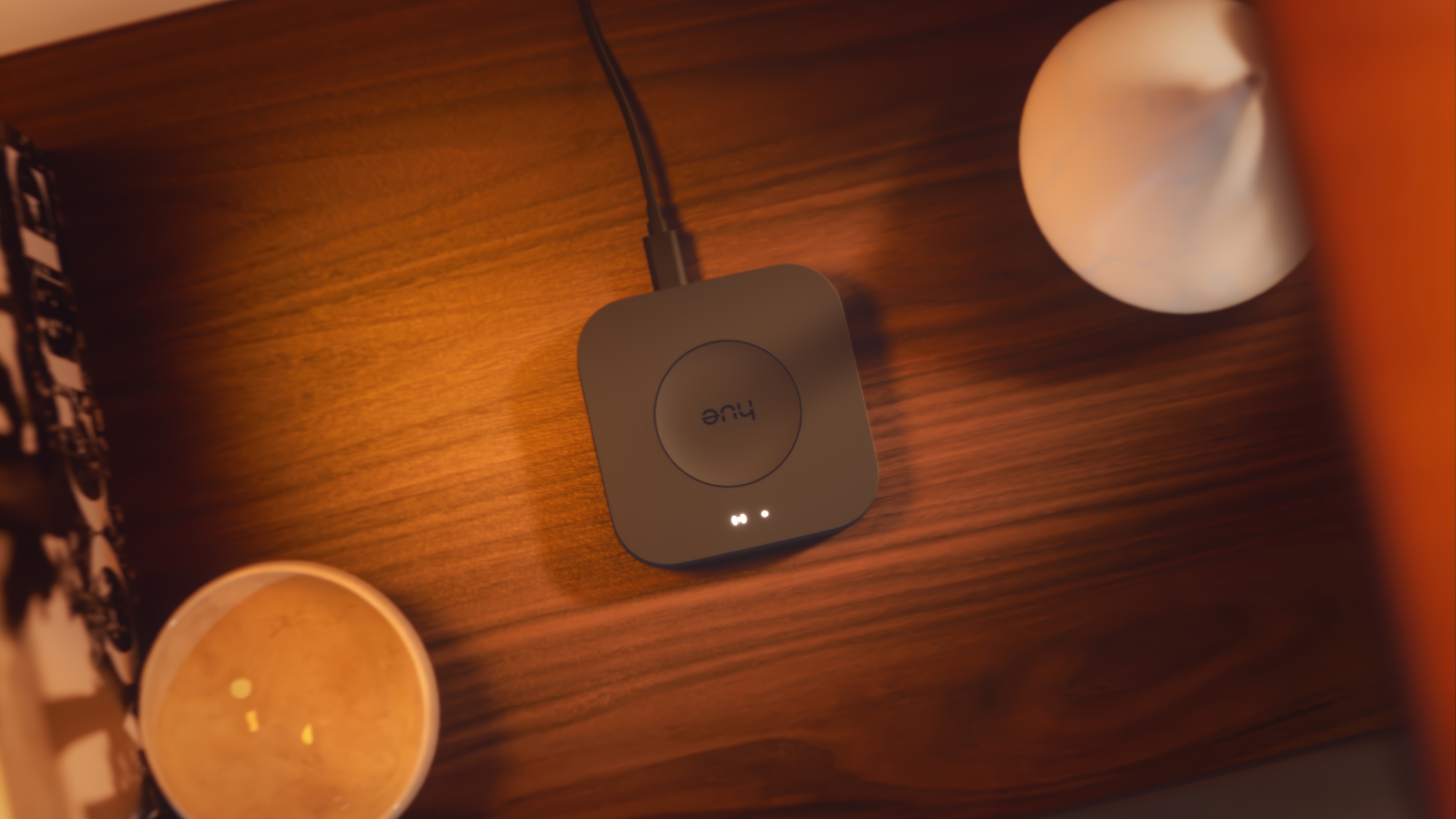 Philips Hue Bridge Pro, a Matter smart home standard hub, mounted on a wood surface