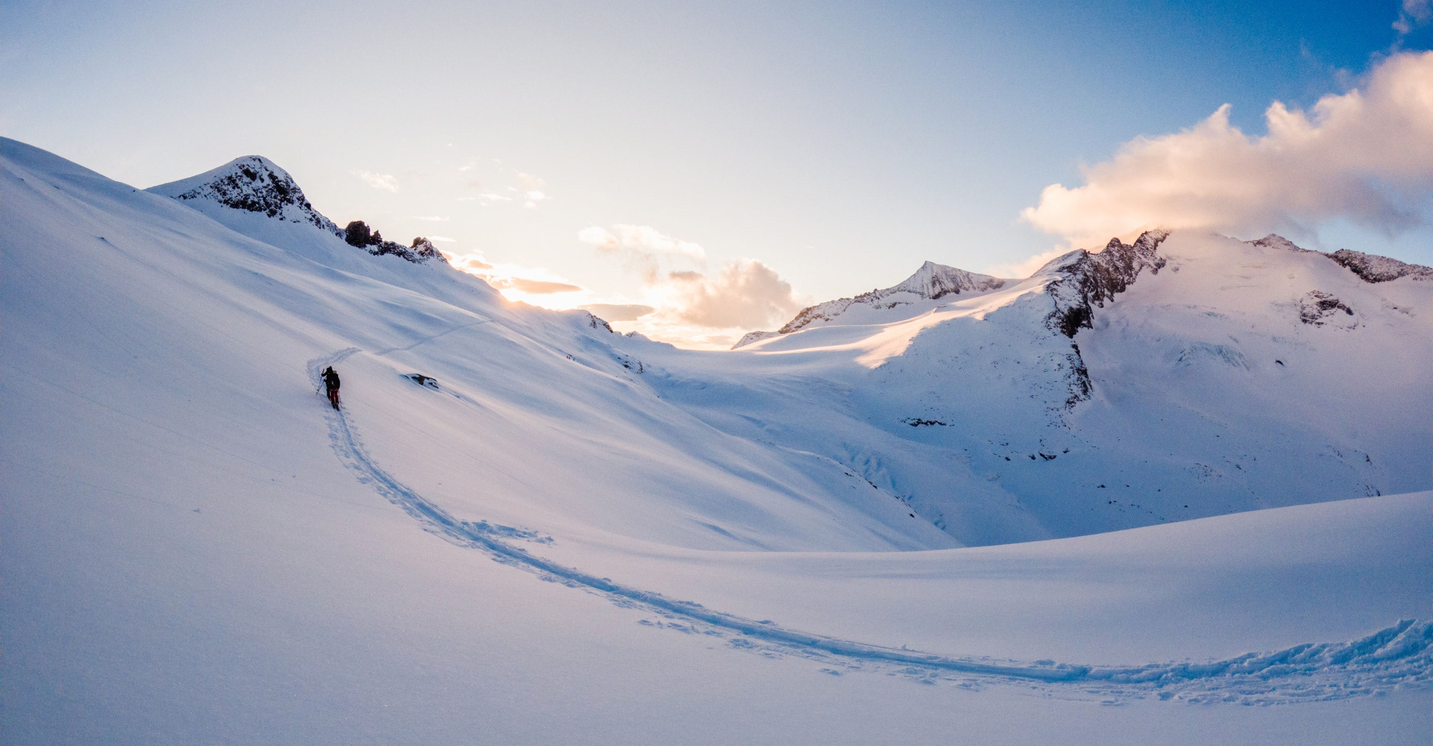 Ski-tourer crossing a snowfield at sunrise filmed on the GoPro Hero 13 Black
