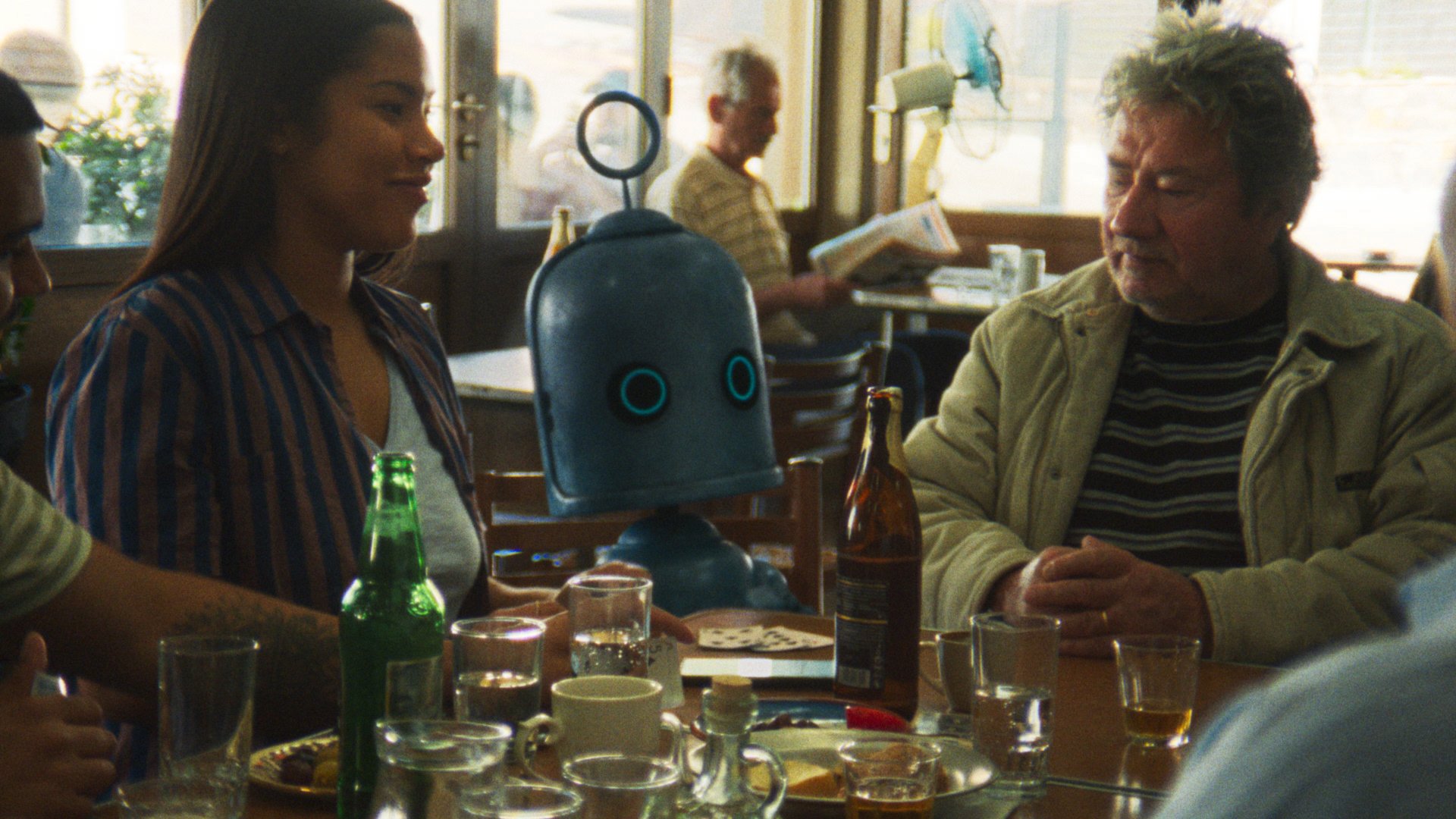 O2 Bubl mascot sitting at a cafe table with a family abroad in the O2 EU roaming campaign