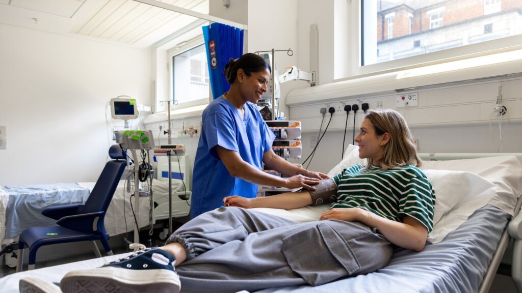 An NHS nurse with a patient as NHS England scales Microsoft 365 Copilot across staff