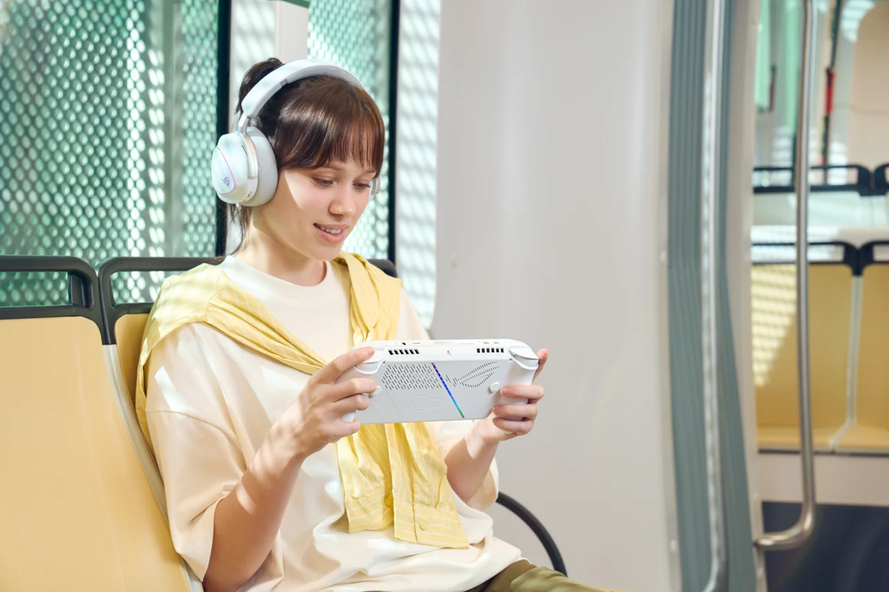 Asus ROG Xbox Ally white handheld being played on a train