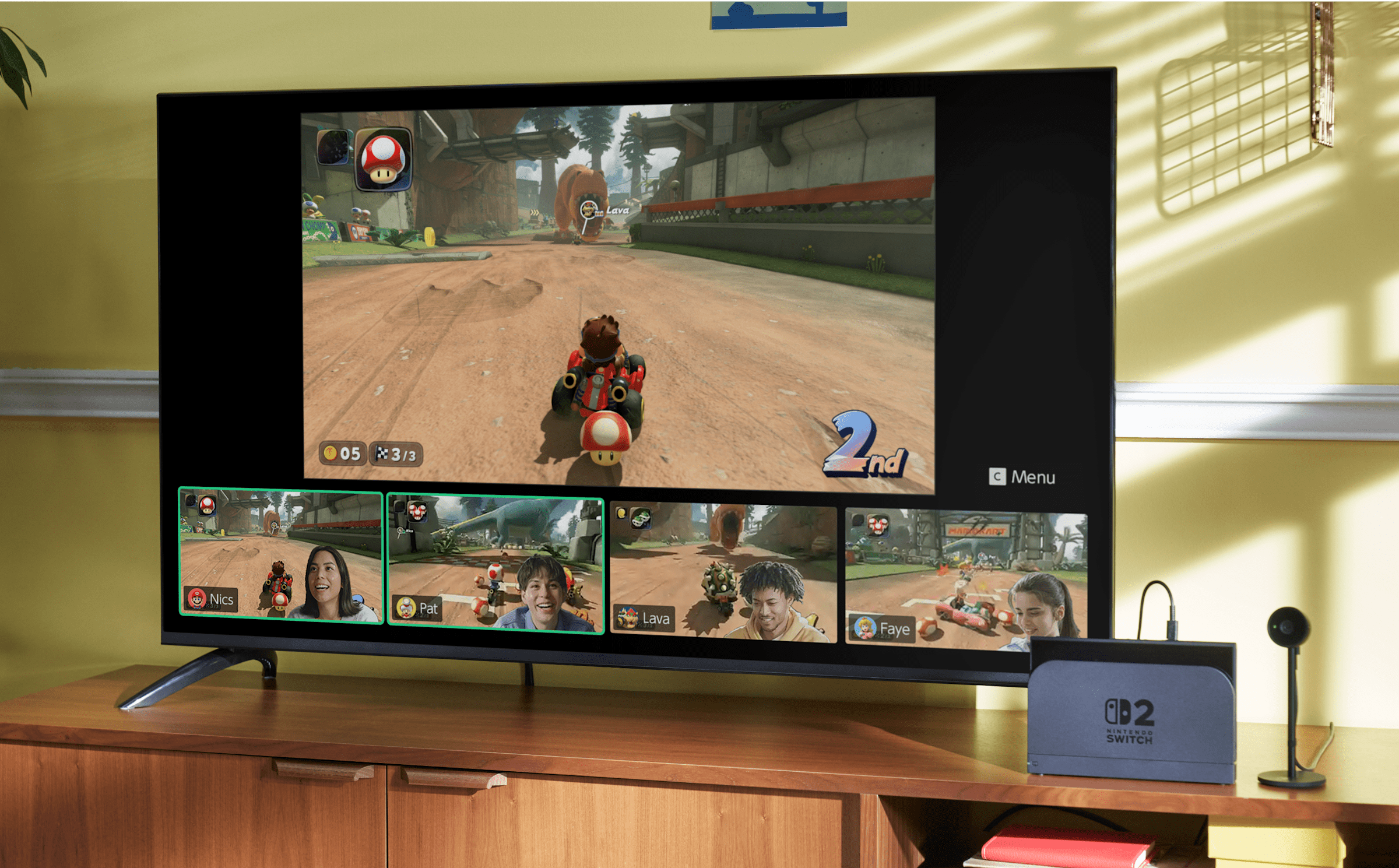 Nintendo Switch 2 console docked to a living-room TV running Mario Kart World in GameChat with four player video tiles