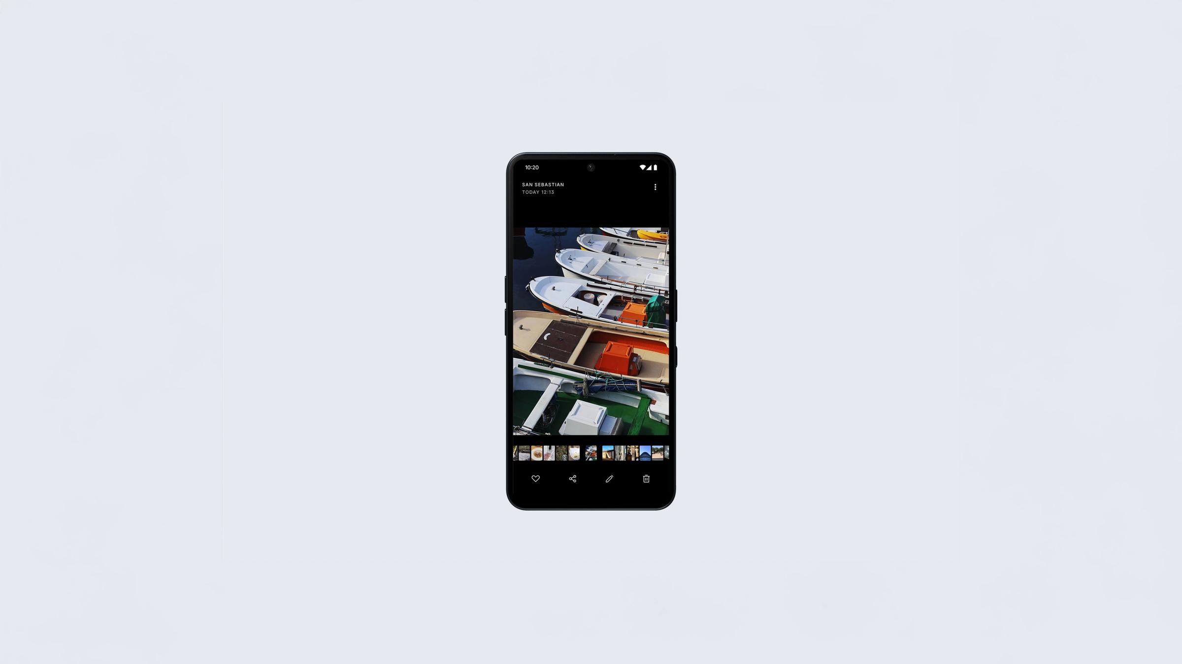 Nothing Phone 3a held showing the 6.77 inch AMOLED display with the photo gallery open