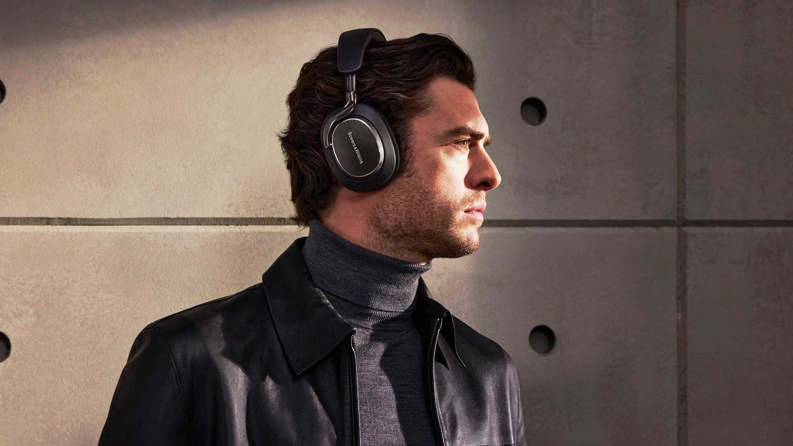 Bowers & Wilkins Px8 S2 headphones resting on a wooden table